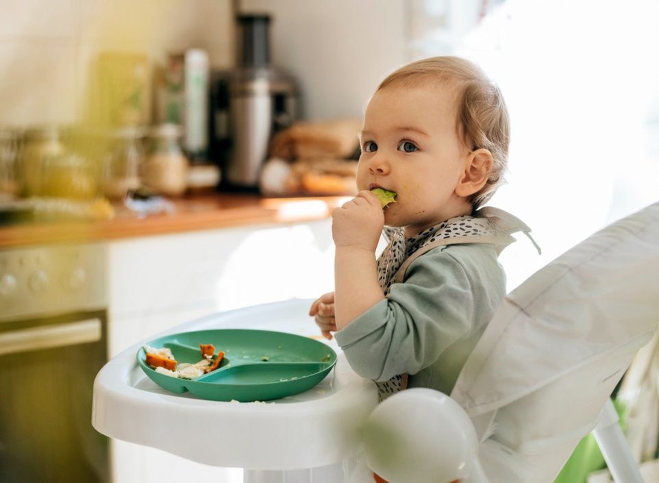 Baby eating in a high chair